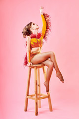 Contemporary dance. A little girl performs a complex acrobatic dance. Modern dance on a bright colorful background.