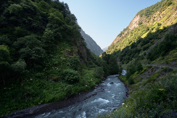 Landscape of a mountain valley with a rapid river.