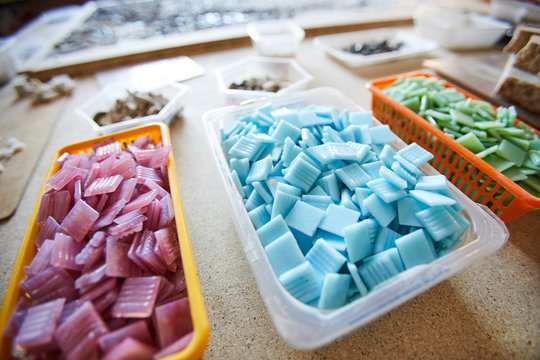 Close up shot of colored square tiles prepared for work in mosaic workshop