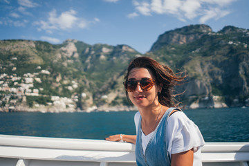 Fototapeta na wymiar girl on a boat on a mountain background