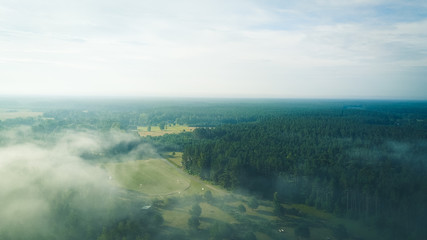 Misty sunrise over countryside path Aerial view Latvia