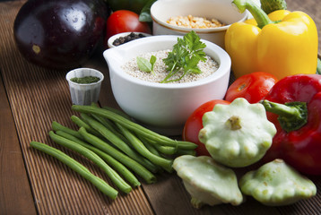 Health food with high fibre. Dieting, whole wheat cereals, grains, vegetables, antioxidants and vitamins: zzuchini, tomatoes, cucumbers, beans. Rustic wooden background top view.