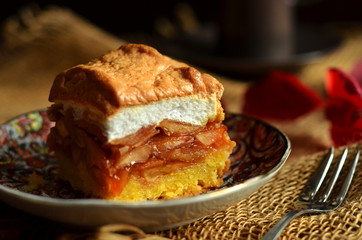 A square piece of apple pie on a rustic plate
