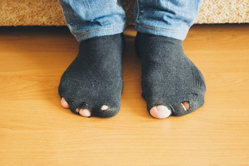 A man is sitting in a leaky socks