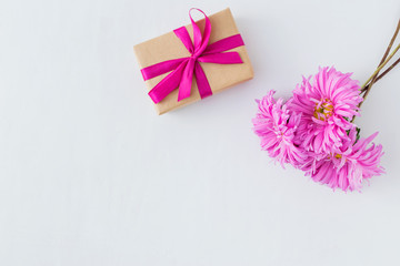 Pink flowers with gift box on white background
