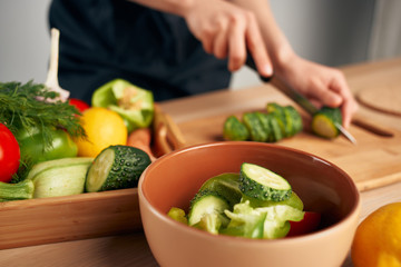 woman preparing salad in kitchen