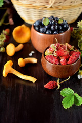 Strawberries, blueberries and chanterelles. Freshly picked forest berries and mushrooms