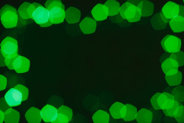 Abstract bokeh lights with soft light background. Green Christmas frame with copy space.