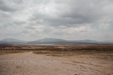 Farmland and hazy mountains in the distance of the arid landscape of southern Bolivia