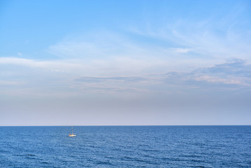 alone yacht sailing in the sea under sky