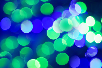 Fototapeta premium Abstract blur bokeh in green and blue color for background. Christmas and New Year defocused texture.