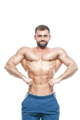 Fototapeta premium bodybuilder posing. Beautiful sporty guy male power. Fitness muscled in blue shorts. on isolated white background. Man with muscular torso. Strong Athletic Man Fitness Model Torso showing six pack abs