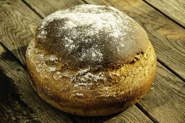 Rustic bread on a wooden background.