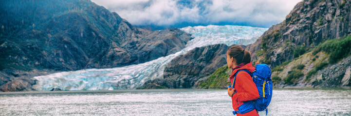 Alaska glacier travel destination Mendenhall tourist attraction in Juneau, USA. Woman walking at ice landscape background panoramic.