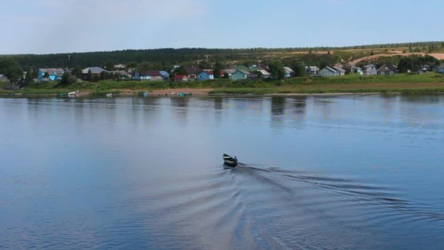 boat crossing across the river in the Northern Russian village