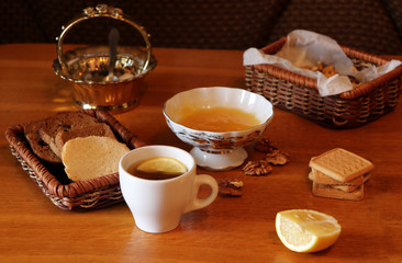 still life tea drinking tea with lemon and honey and biscuits with sugar and bread traditional breakfast