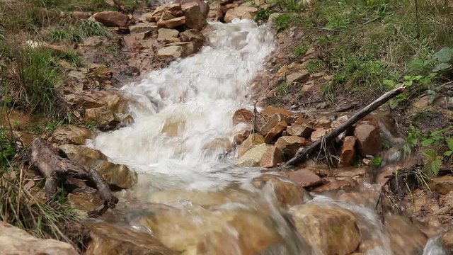 Mountain water flow, free river on rocks, waterfall.