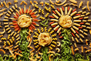 A lot of colorful pasta on a wood background from above
