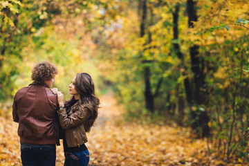 Young couple in love hugging in autumn park.