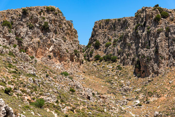 Fototapeta na wymiar Vreiko Cave Pass Lasithi Makrigialos mountains wonderland tour, steep slopes, rocky peaks for hiking adventure recreation sports in Crete, Greece.