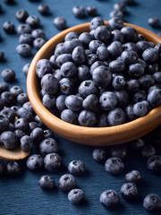 Closeup of fresh blueberries in a wooden plate