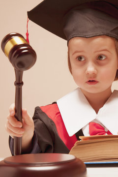  Humorous portrait of cute little child girl as a judge.