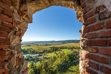 Picturesque rural landscape seen through the ruins of the castle in Czorsztyn. Poland