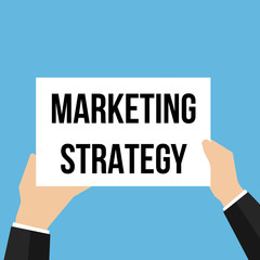 Man showing paper MARKETING STRATEGY text 