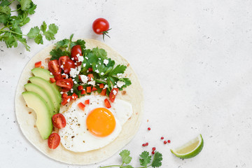 Flatbread with avocado, egg and mexican salsa. Top view with copy space for text. Healthy breakfast or lunch food