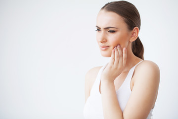 Naklejka premium Tooth Pain. Woman Feeling Tooth Pain. Closeup Of Beautiful Sad Girl Suffering From Strong Tooth Pain. Attractive Female Feeling Painful Toothache. Dental Health And Care Concept