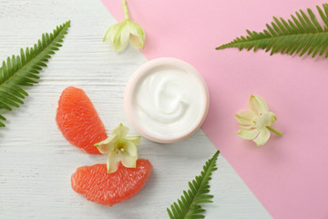 Beautiful composition with jar of cream on colorful background, flat lay