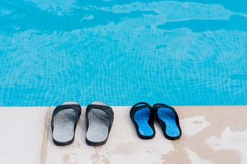 Couple of flip flops near pool