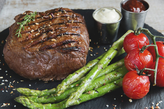 beef steak with asparagus tomatoes sauce