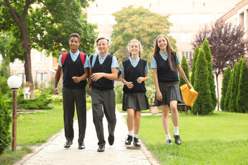Teenage students in stylish school uniform outdoors
