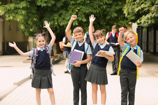 Little children in stylish school uniform outdoors