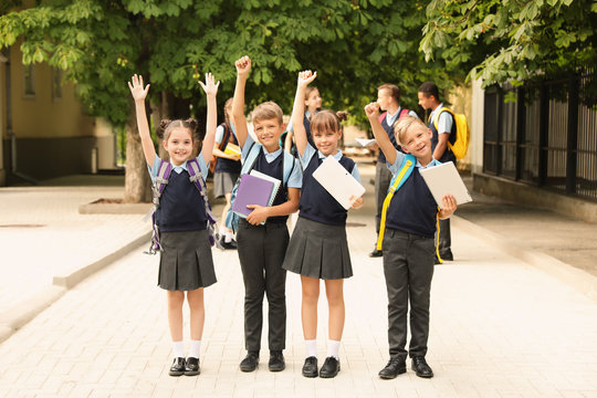 Little children in stylish school uniform outdoors