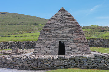 Fototapeta na wymiar Irlande - Péninsule de dingle - Oratoire de Gallarus près d'une tombe ancienne
