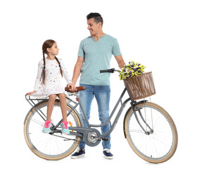 Portrait of father and his daughter with bicycle on white background