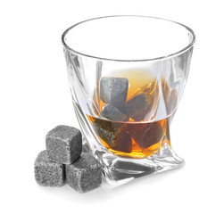 Glass with liquor and whiskey stones on white background