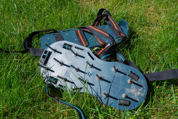 Spiked lawn revitalizing aerating shoes, gardening concept. Garden care.