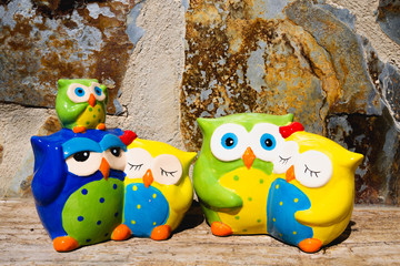 Cute Owls. Decorative of Ceramic Owl. Owl toy. Beautiful composition with family of owls. Symbol of knowledge, concept of teaching and school.