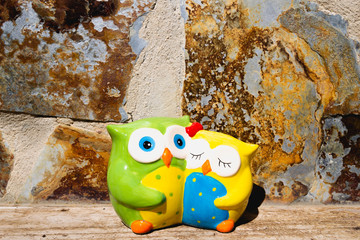 Cute Owls. Decorative of Ceramic Owl. Owl toy. Beautiful composition with couple of owls.  Symbol of knowledge, concept of teaching and school.