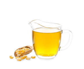 Jug with fresh corn oil and kernels on white background