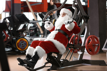 Authentic Santa Claus training in modern gym © New Africa