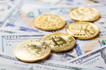 Bitcoins on dollar banknotes background