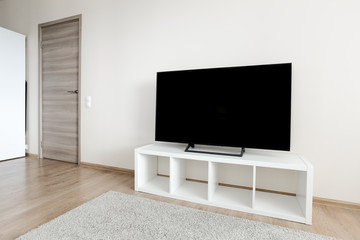 Lcd tv on white shef at modern room interior
