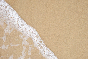 Sea wave on the sandy beach