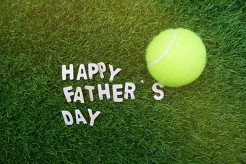 Happy Father's day to Tennis player is on green grass background
