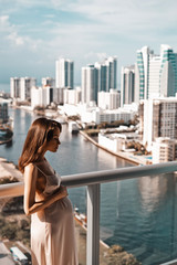 Fototapeta na wymiar Pregnant woman on balcony