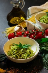 Homemade Fresh Pesto Pasta with ingredients on side